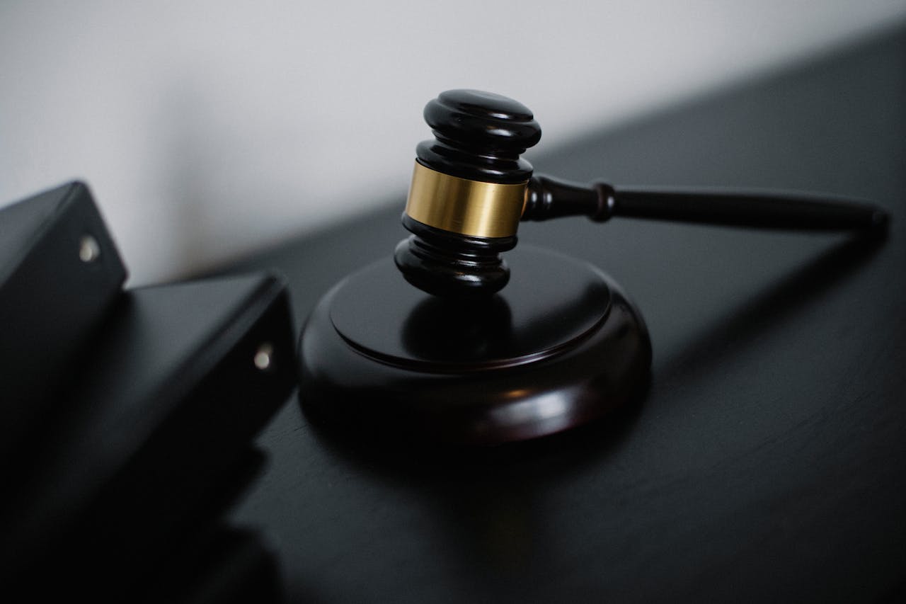 About Close-up of a wooden gavel on a desk, symbolizing justice and legal authority.